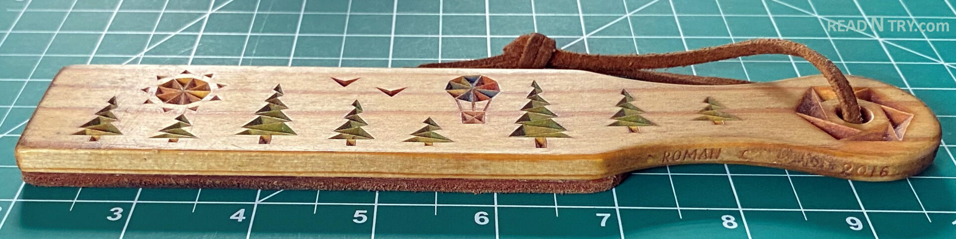A DIY strop with the chip carving embellishment features the Forest chip carving pattern designed by Roman Chernikov at READ N TRY.com in 2016. It is 7 3/4 inches long and was carved from a 1/4-inch-thick basswood board.
