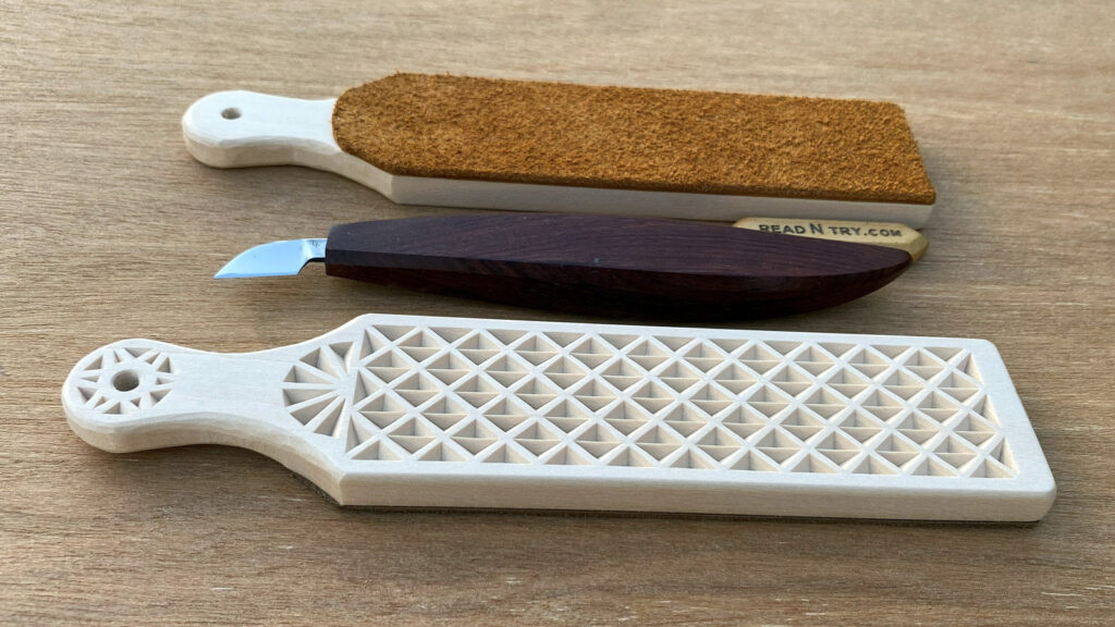 Two DIY strops with a simple chip-carving design on one side and leather on the other. The picture also shows a chip-carving knife. The strops are made from 3/8" basswood board by Roman Chernikov.